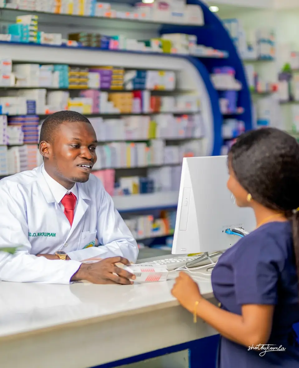 Pharmacist serving a customer at the counter